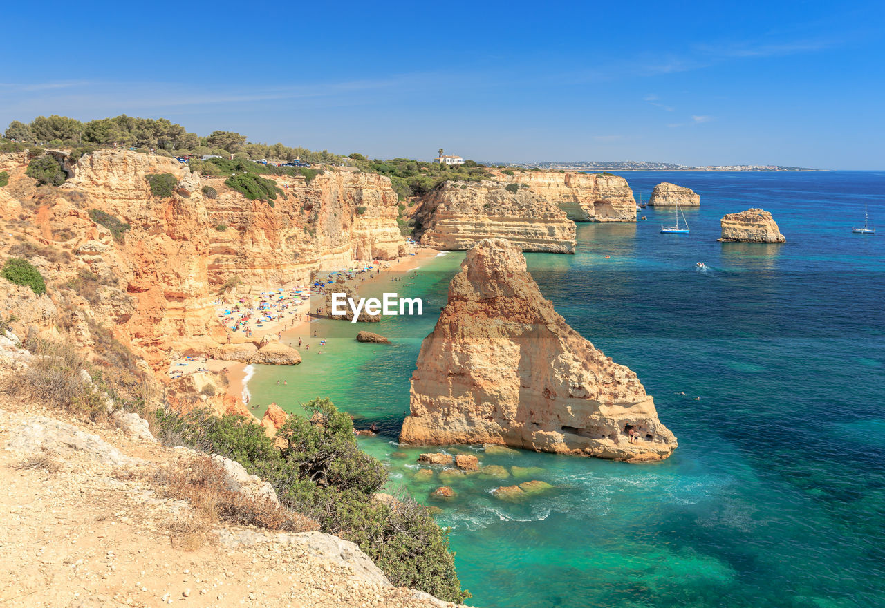 Scenic view of rocks in sea against sky