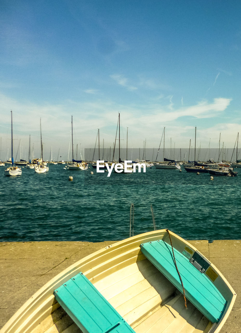 Boats moored in sea against sky