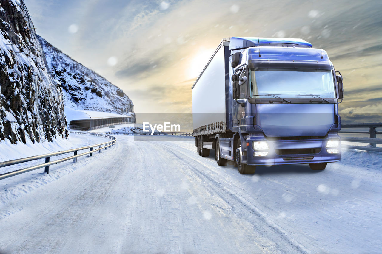 Truck on snow covered road during snowfall