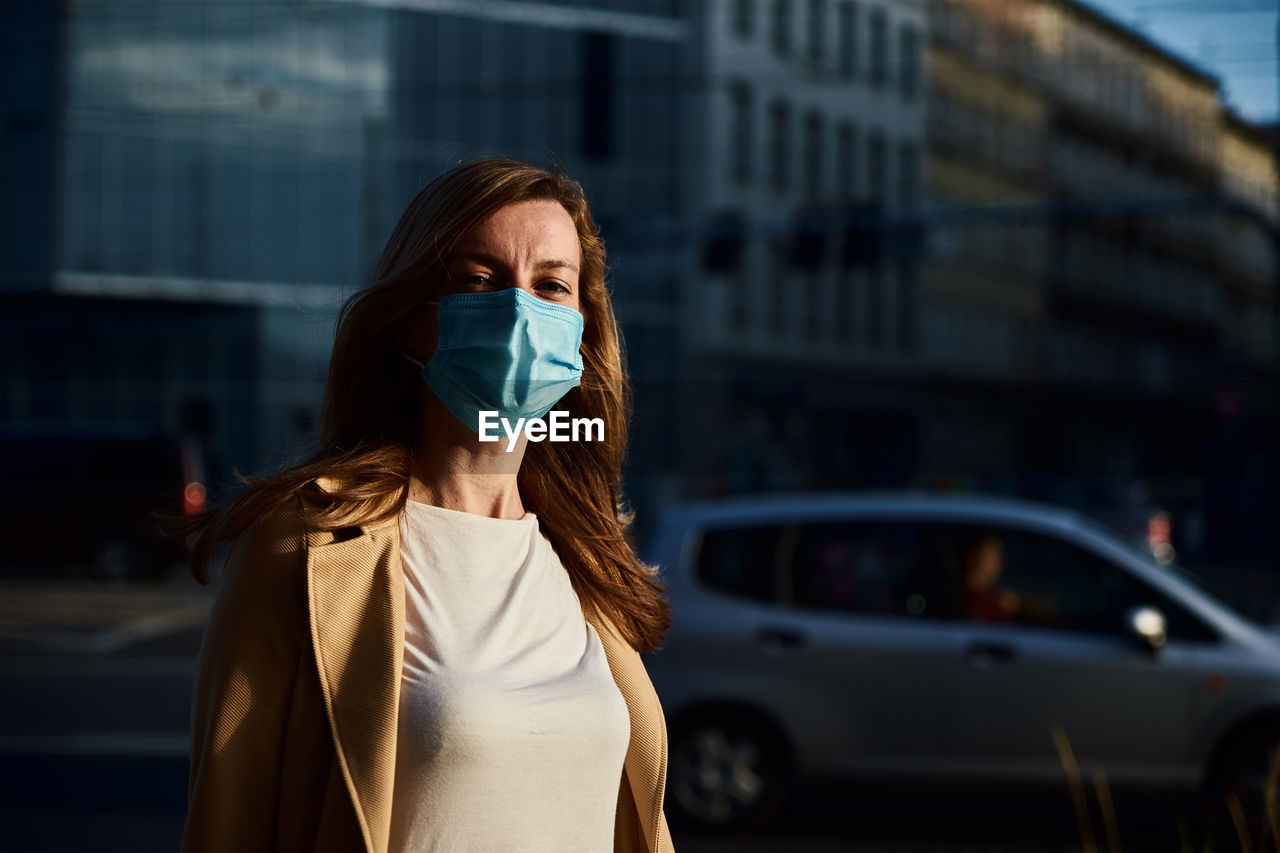 Woman in protective mask at city street