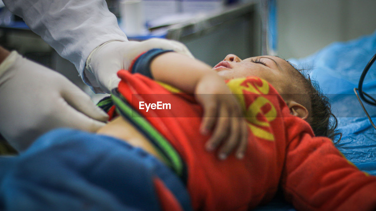 Cropped image of doctor examining baby at hospital