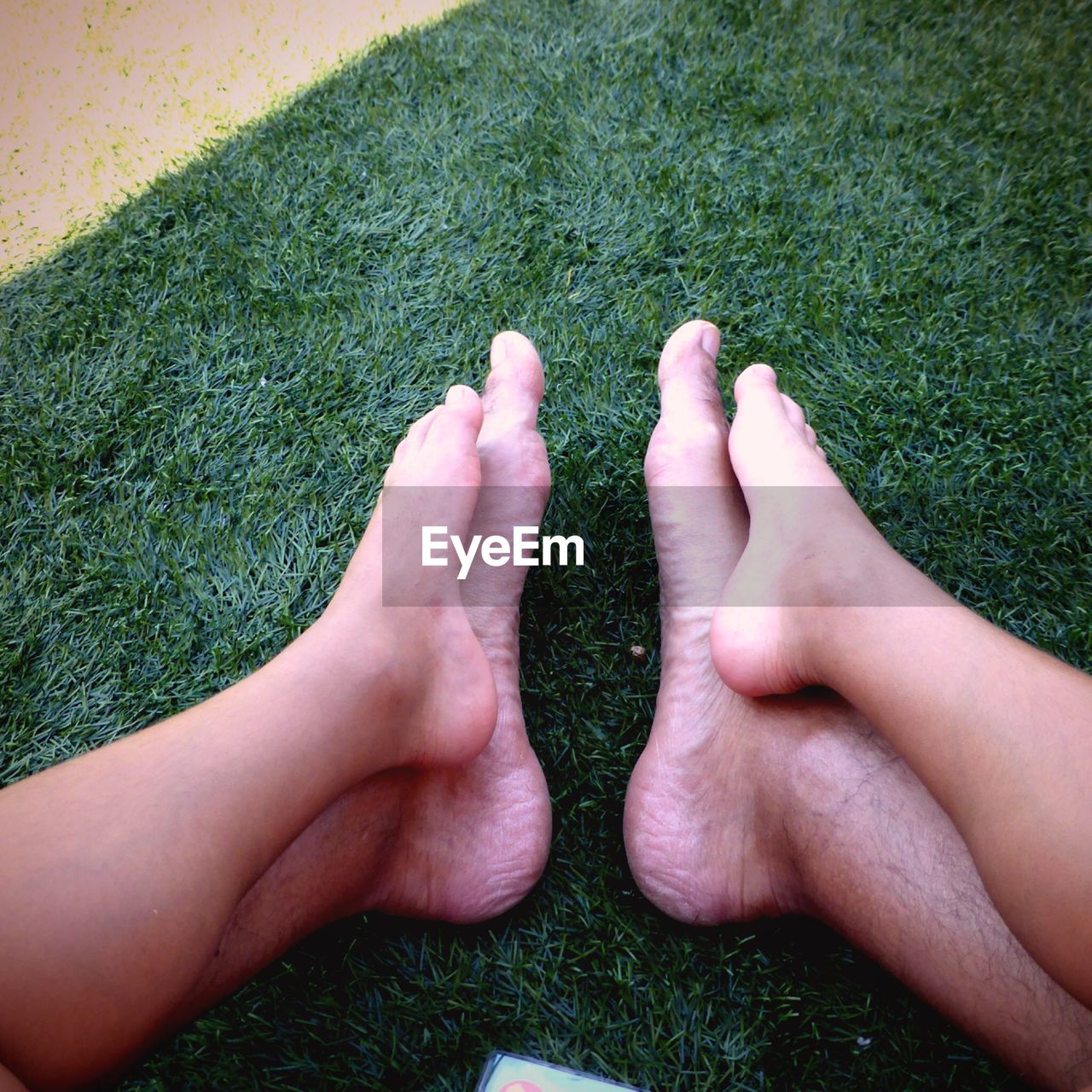 LOW SECTION OF PERSON LEGS ON GRASS