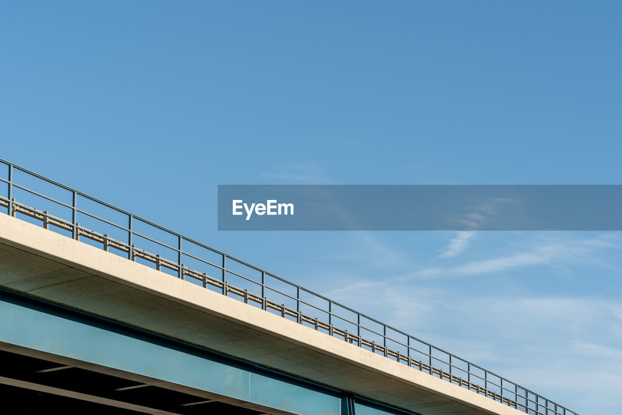 Low angle view of bridge against clear blue sky