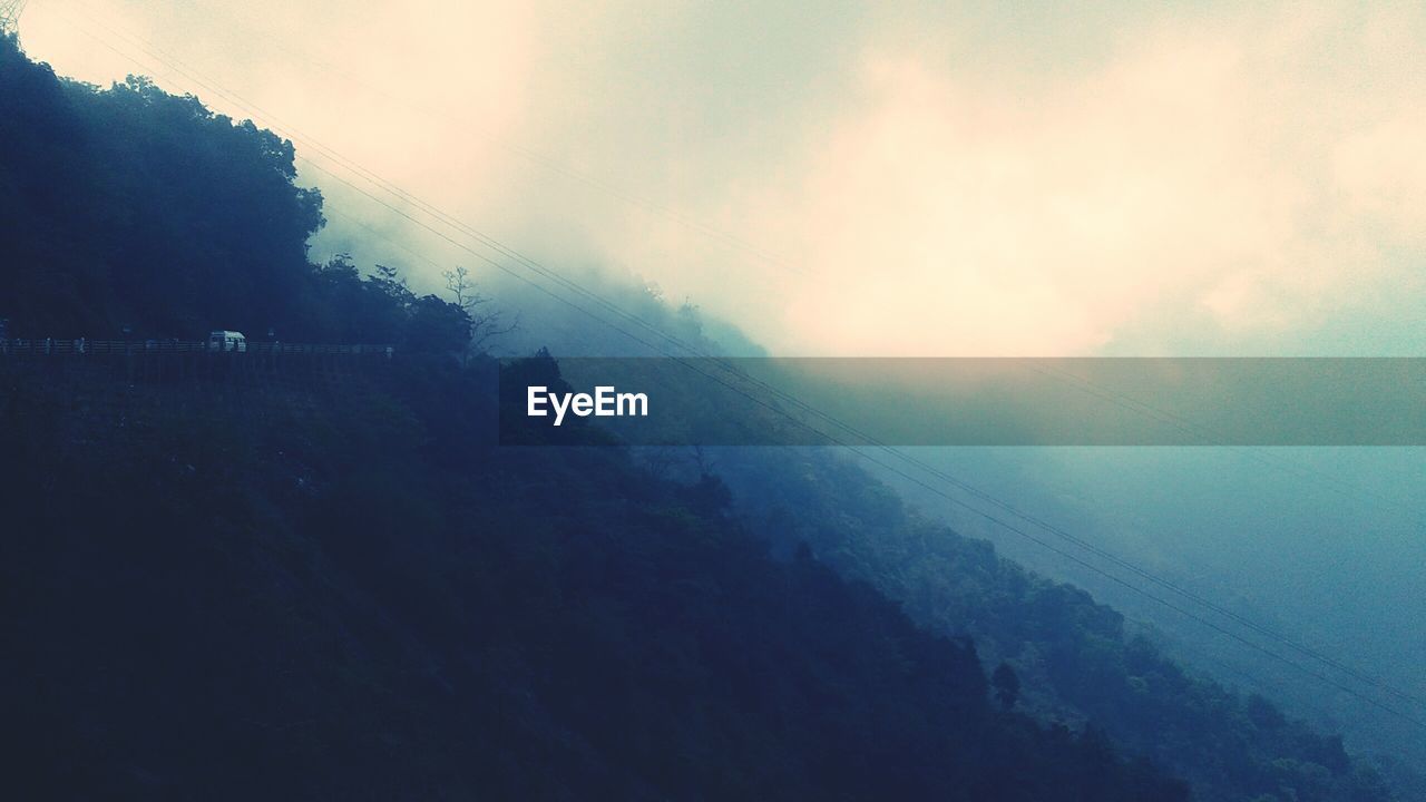 SCENIC VIEW OF MOUNTAINS IN FOGGY WEATHER