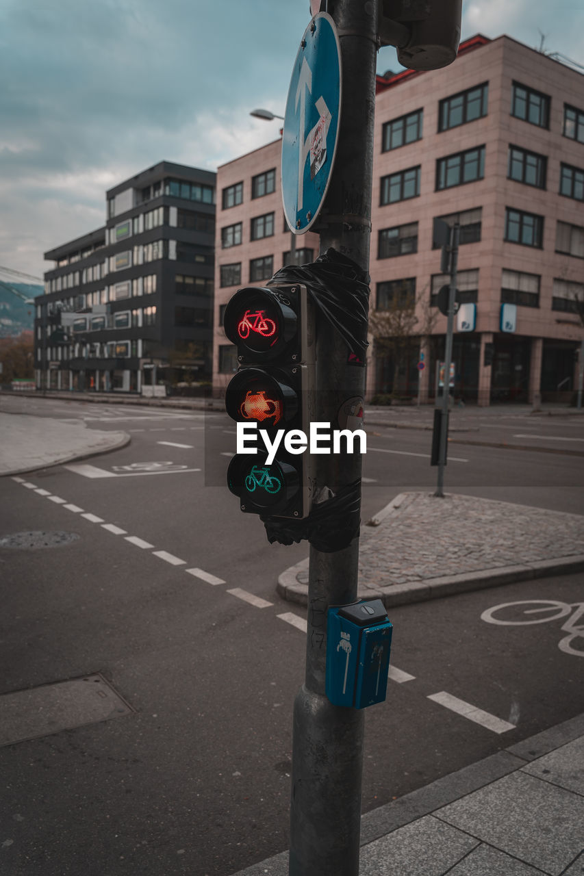 Road signs on pole by city street