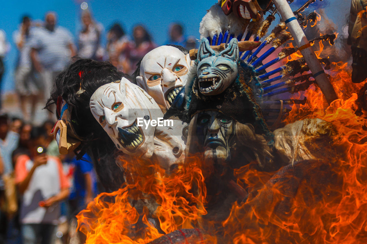 burning, fire, flame, tradition, celebration, event, group of people, mask, carnival, arts culture and entertainment, crowd, nature, outdoors, disguise, festival, heat, traditional festival