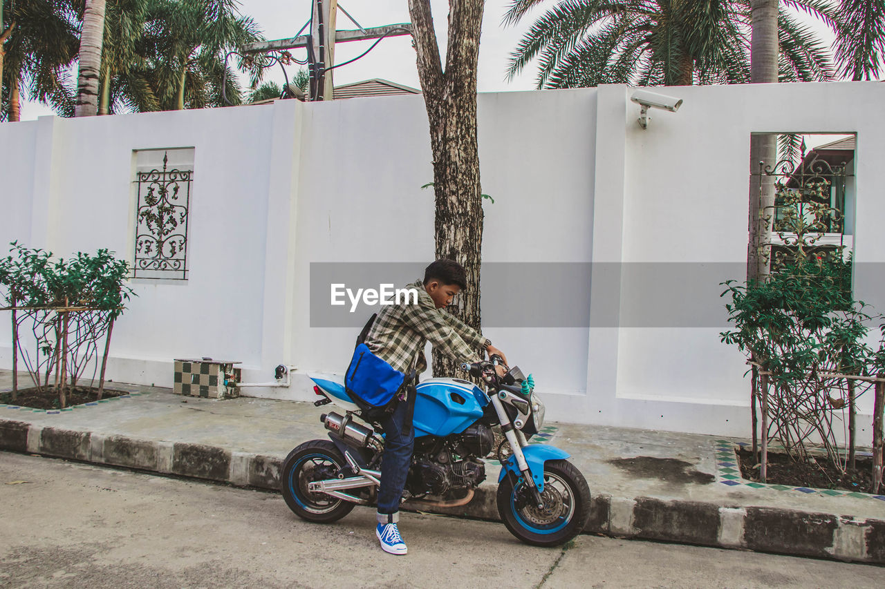 Young man sitting on motorcycle