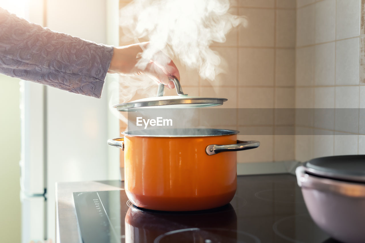 cropped hand of man preparing food