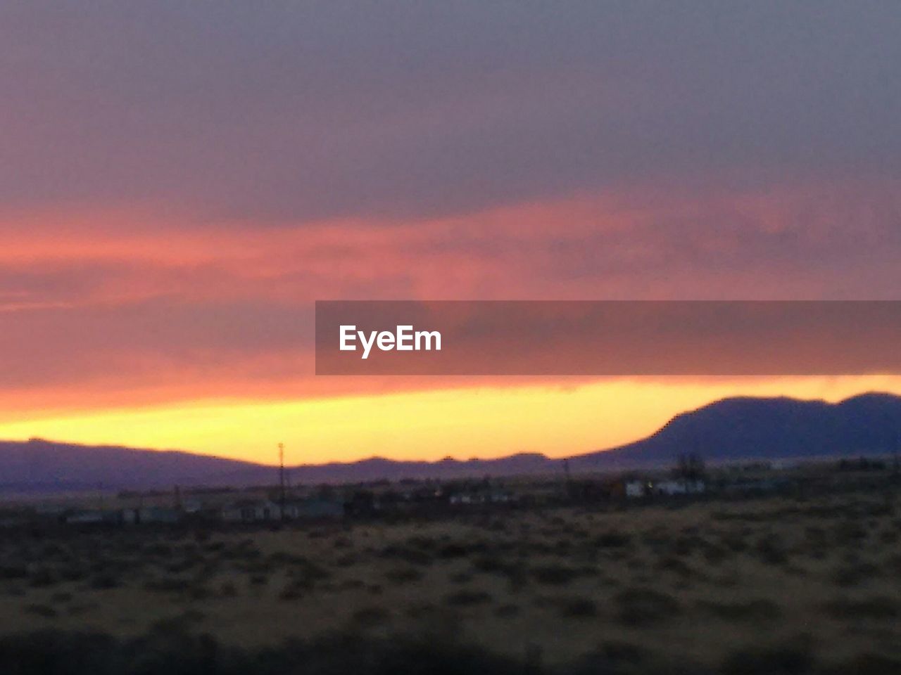 SCENIC VIEW OF MOUNTAINS AT SUNSET