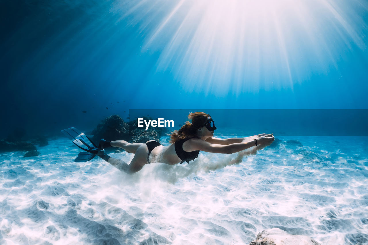 rear view of man swimming in sea