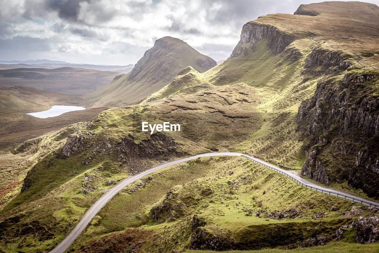 Scenic view of mountains against cloudy sky