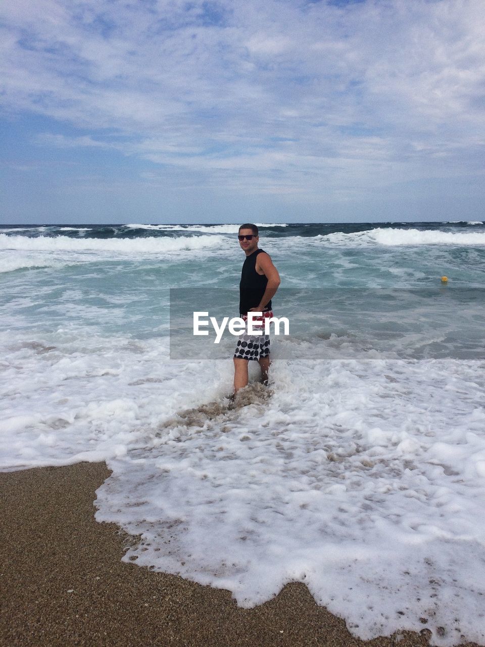 Full length of man standing on beach against sky