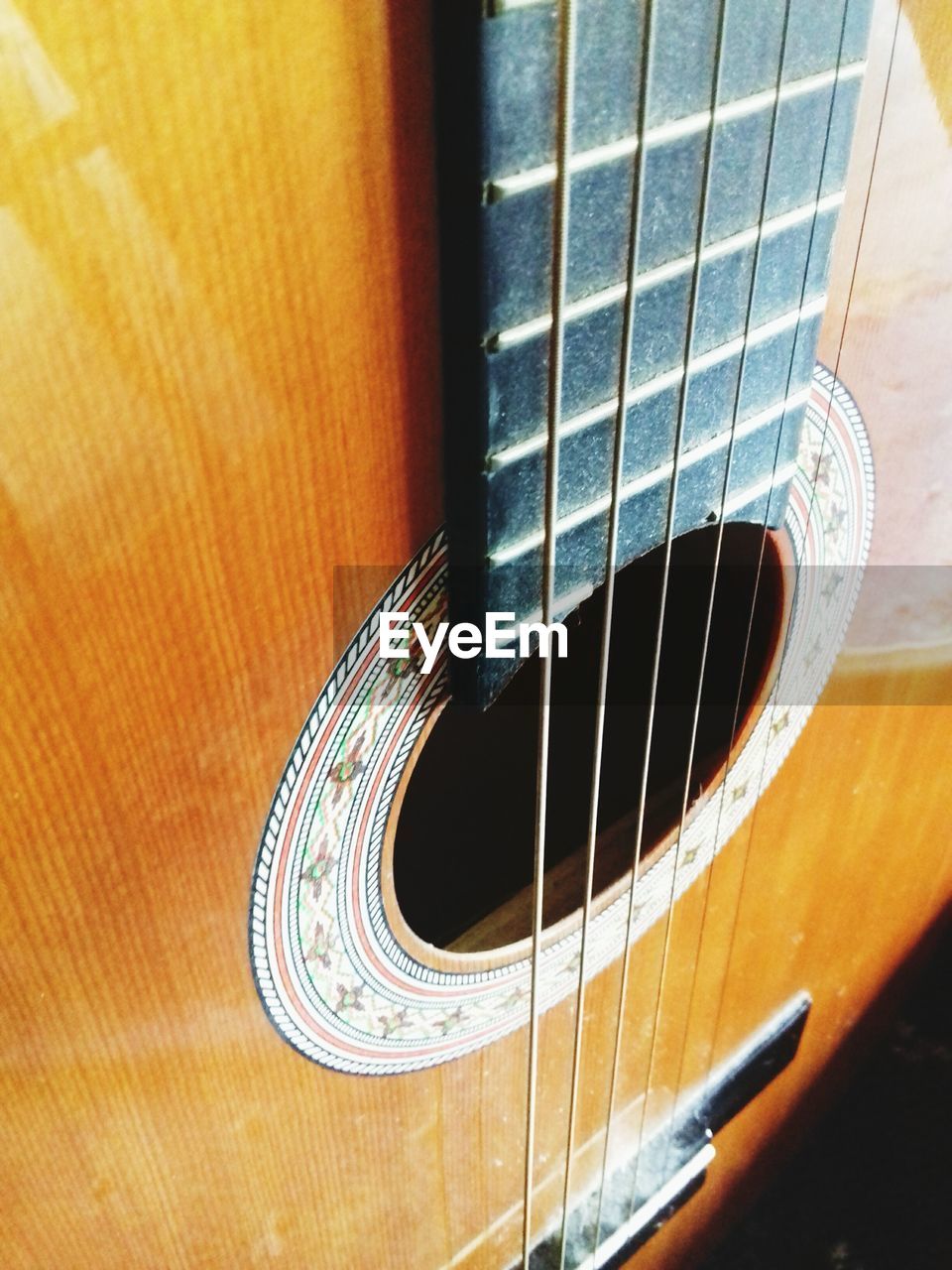 CLOSE-UP OF GUITAR IN THE DARK