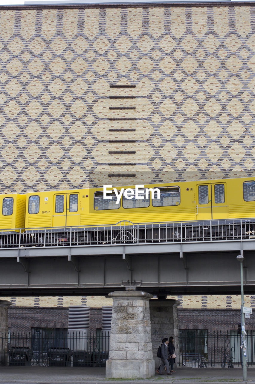 TRAIN AT RAILROAD STATION IN CITY