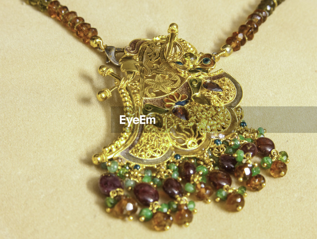 CLOSE-UP OF NECKLACE WITH SEEDS