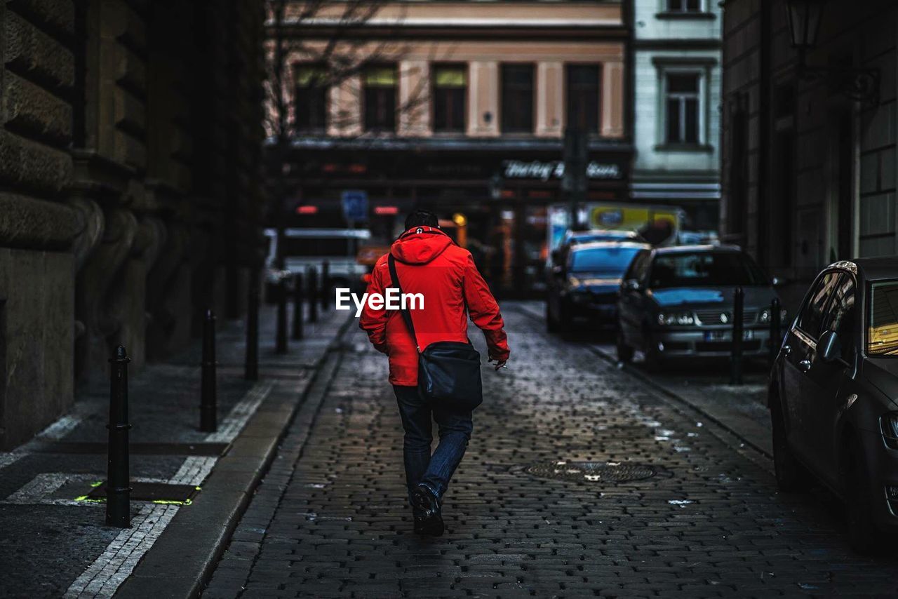 Rear view of man walking on street