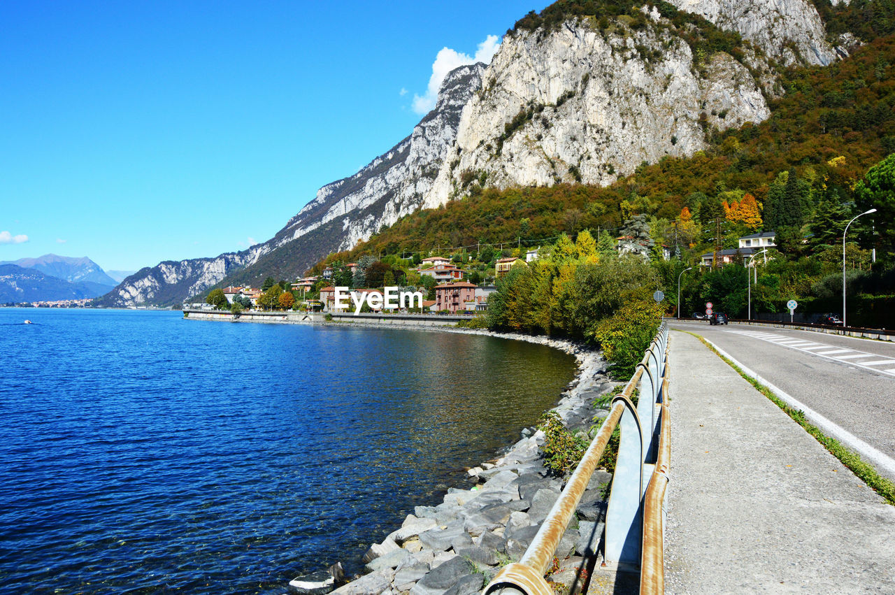 Scenic view of trees and mountains against clear blue sky