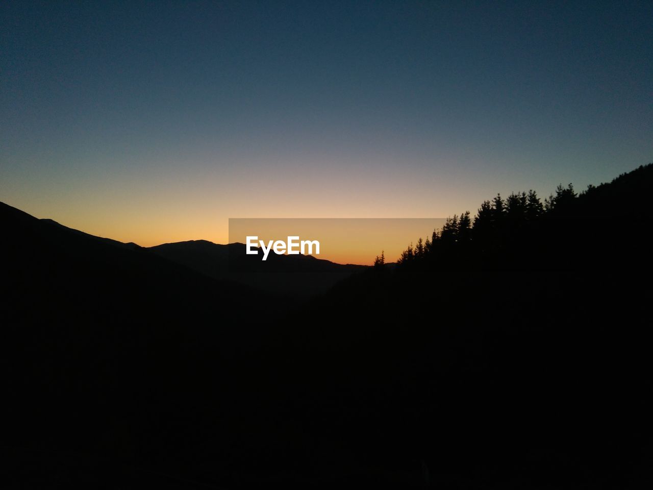 Scenic shot of silhouette mountains against sky at sunset