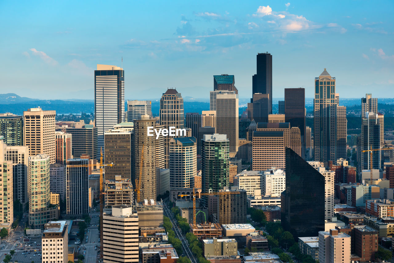 Aerial view of buildings in city against sky