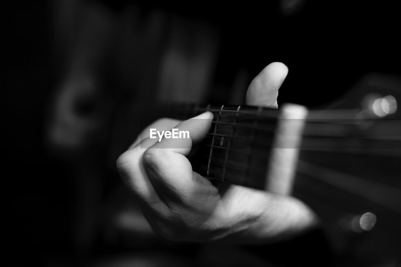 Close-up of hand playing guitar