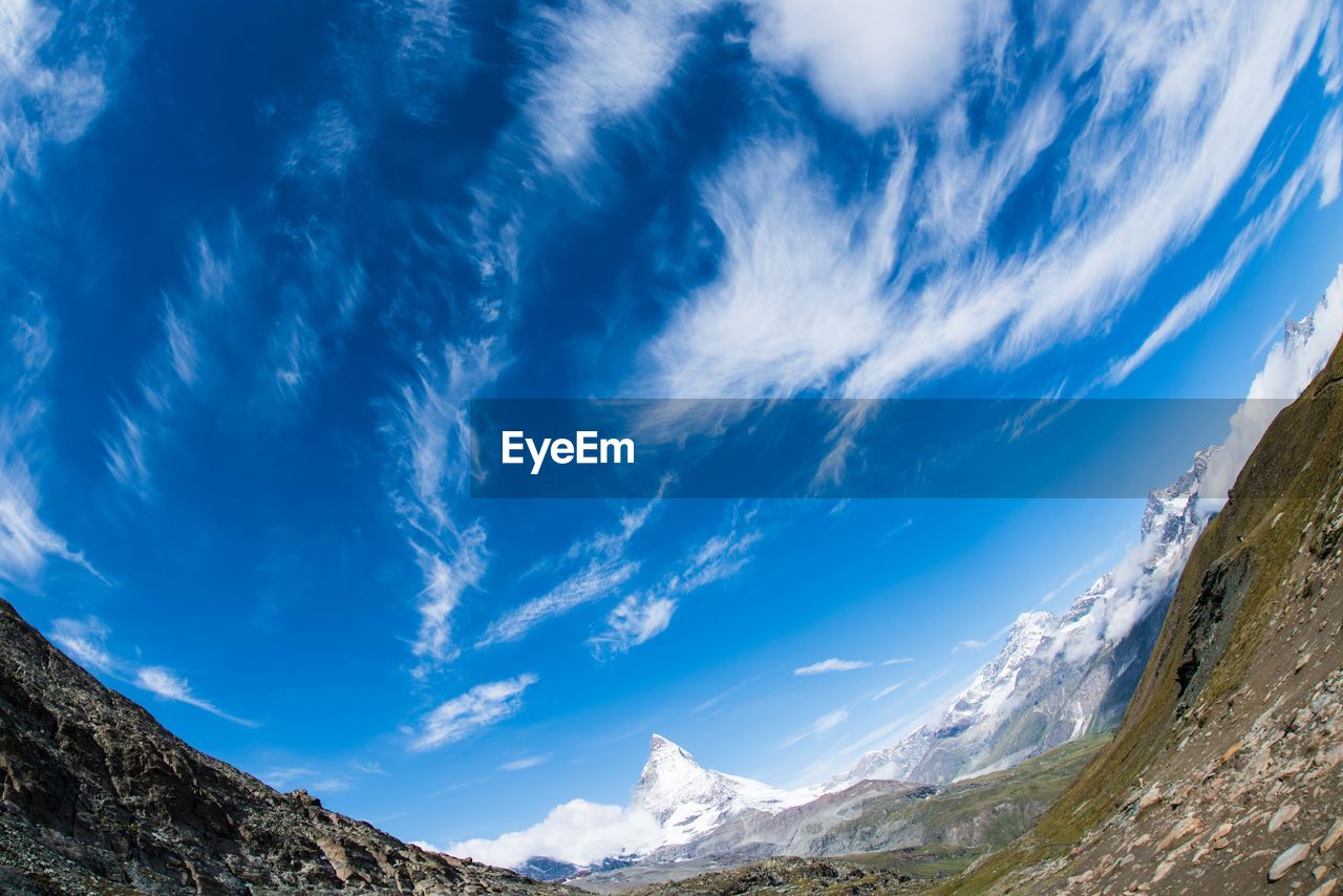 LOW ANGLE VIEW OF MOUNTAIN AGAINST BLUE SKY