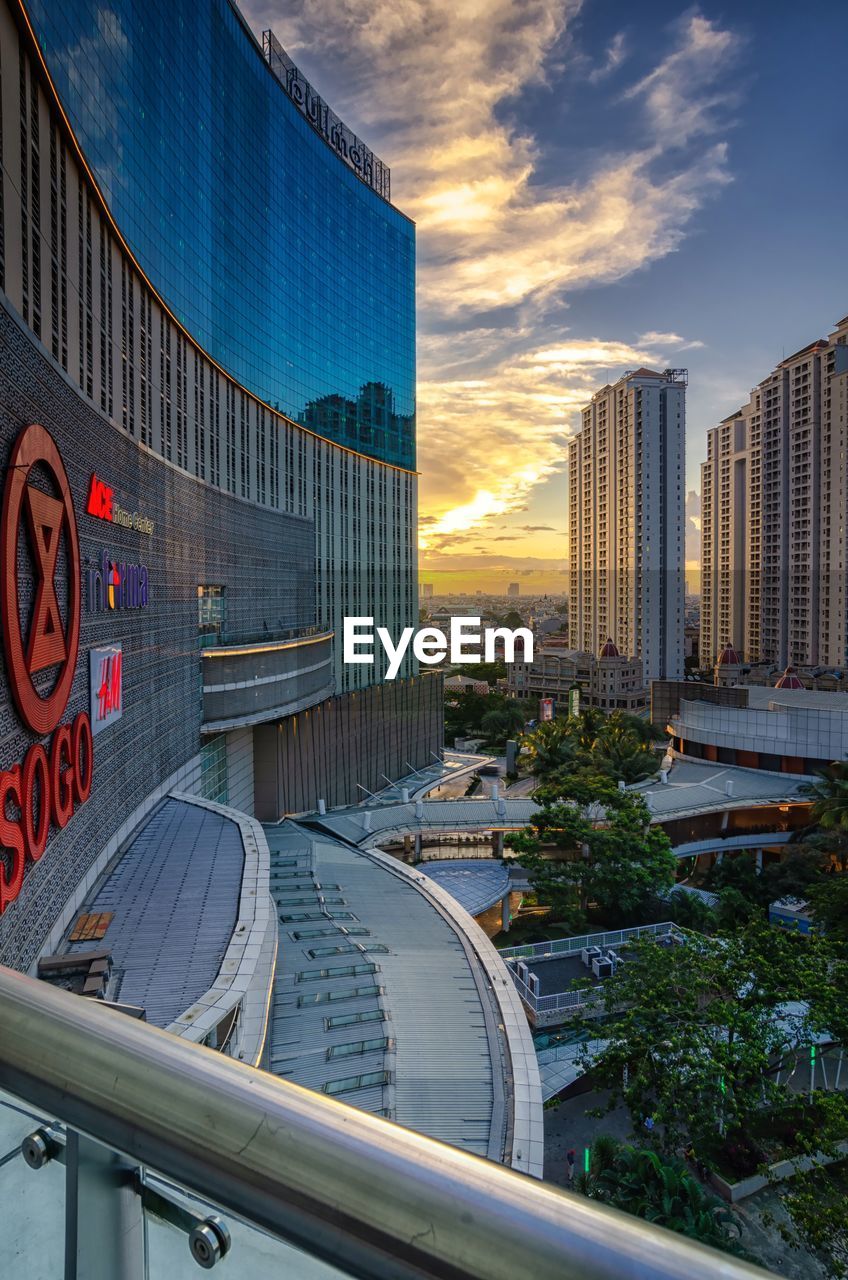 MODERN BUILDINGS AGAINST SKY AT SUNSET