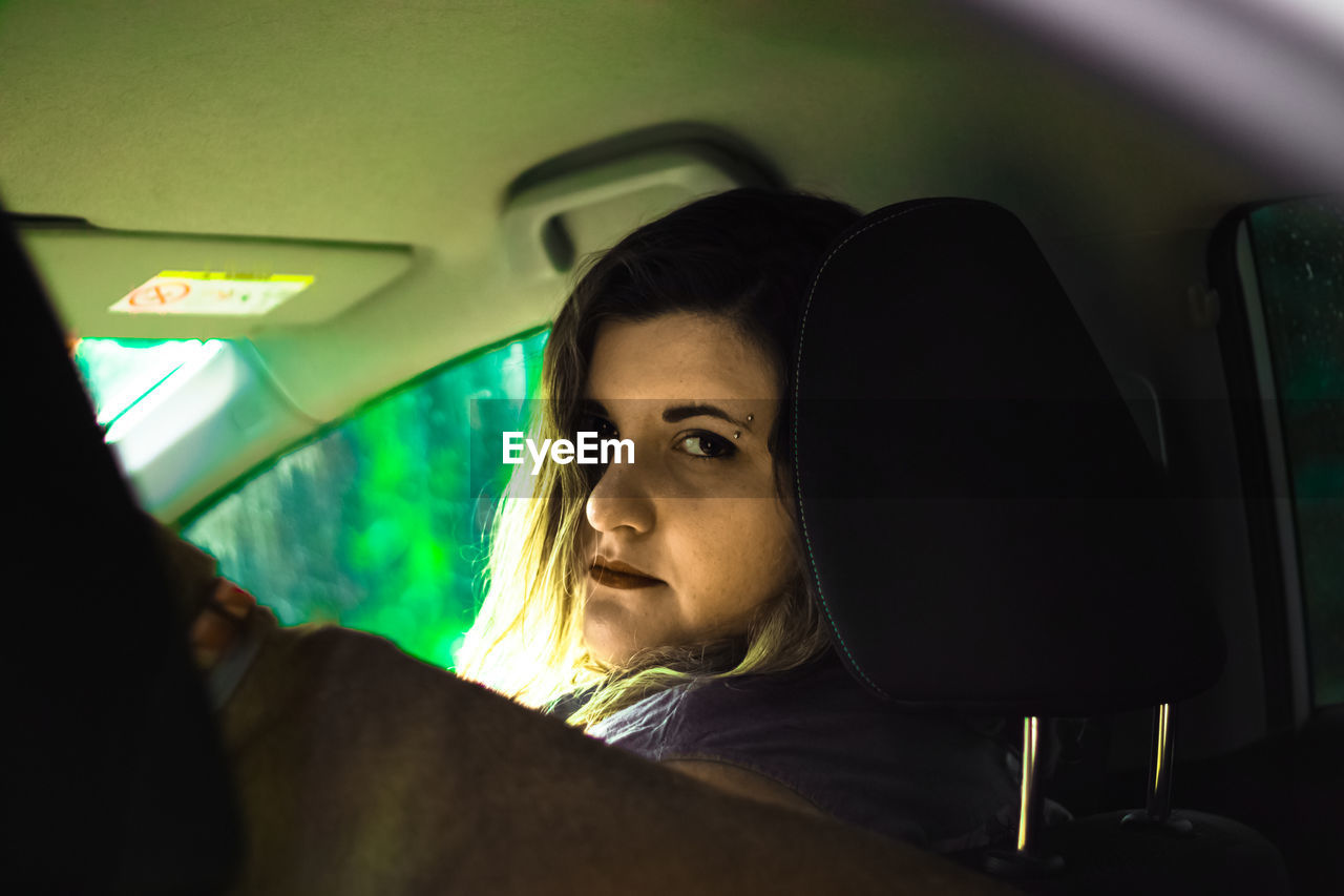 Portrait of woman sitting in car