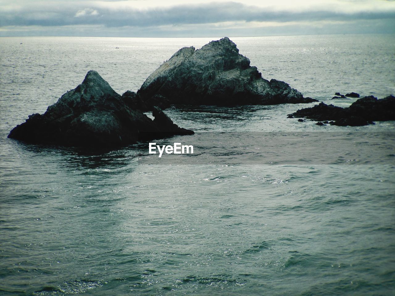 SCENIC VIEW OF SEA WITH ROCKS IN BACKGROUND