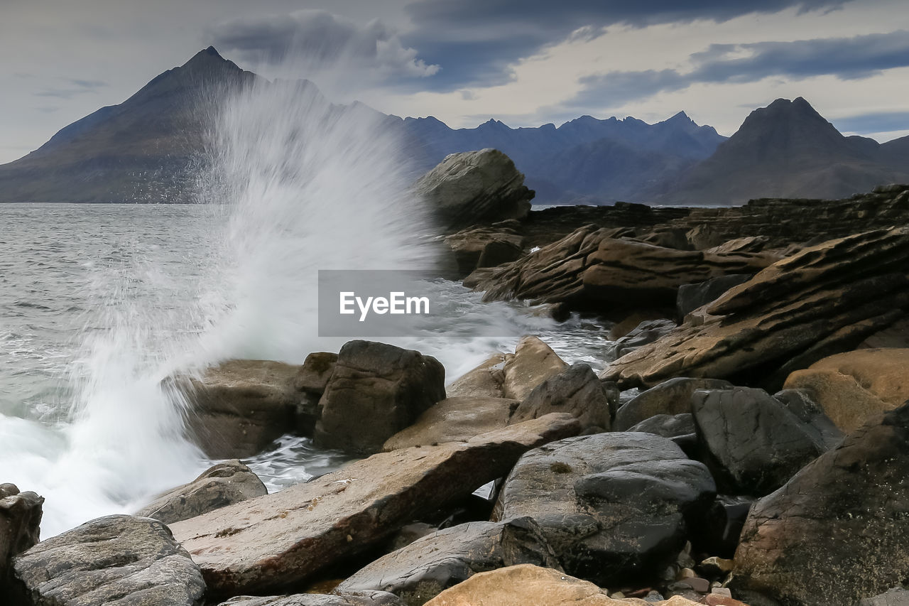 Scenic view of waterfall against sky