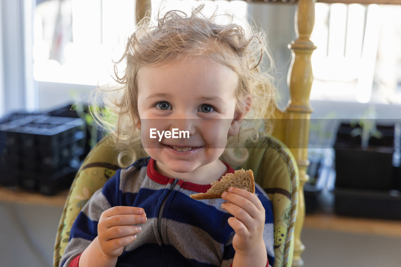 portrait of cute baby girl looking away at home