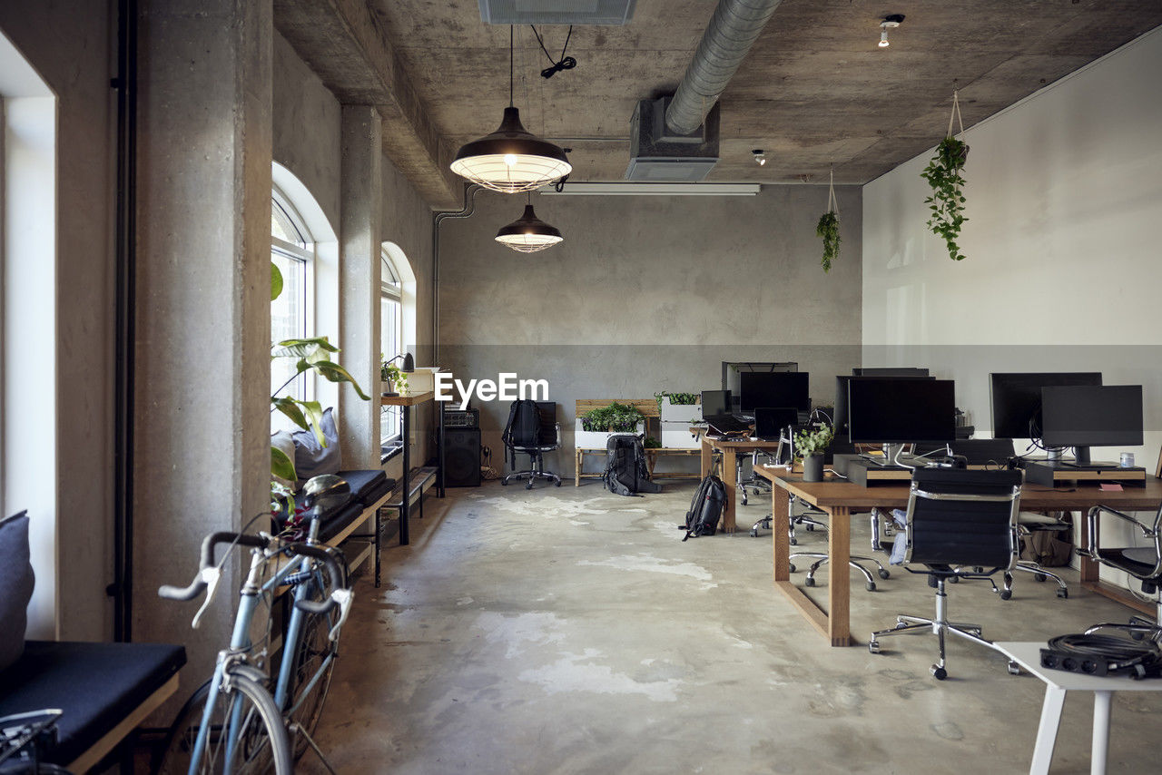 Computers on desks with chairs in office