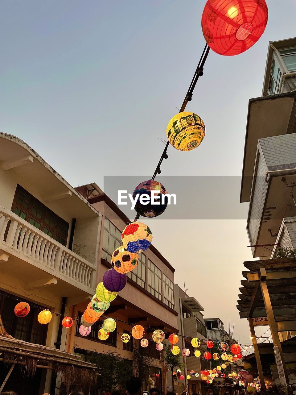 Celebrating mid autumn in hk, lanterns were hanged on the streets of tai o. low angle with bldg, sky