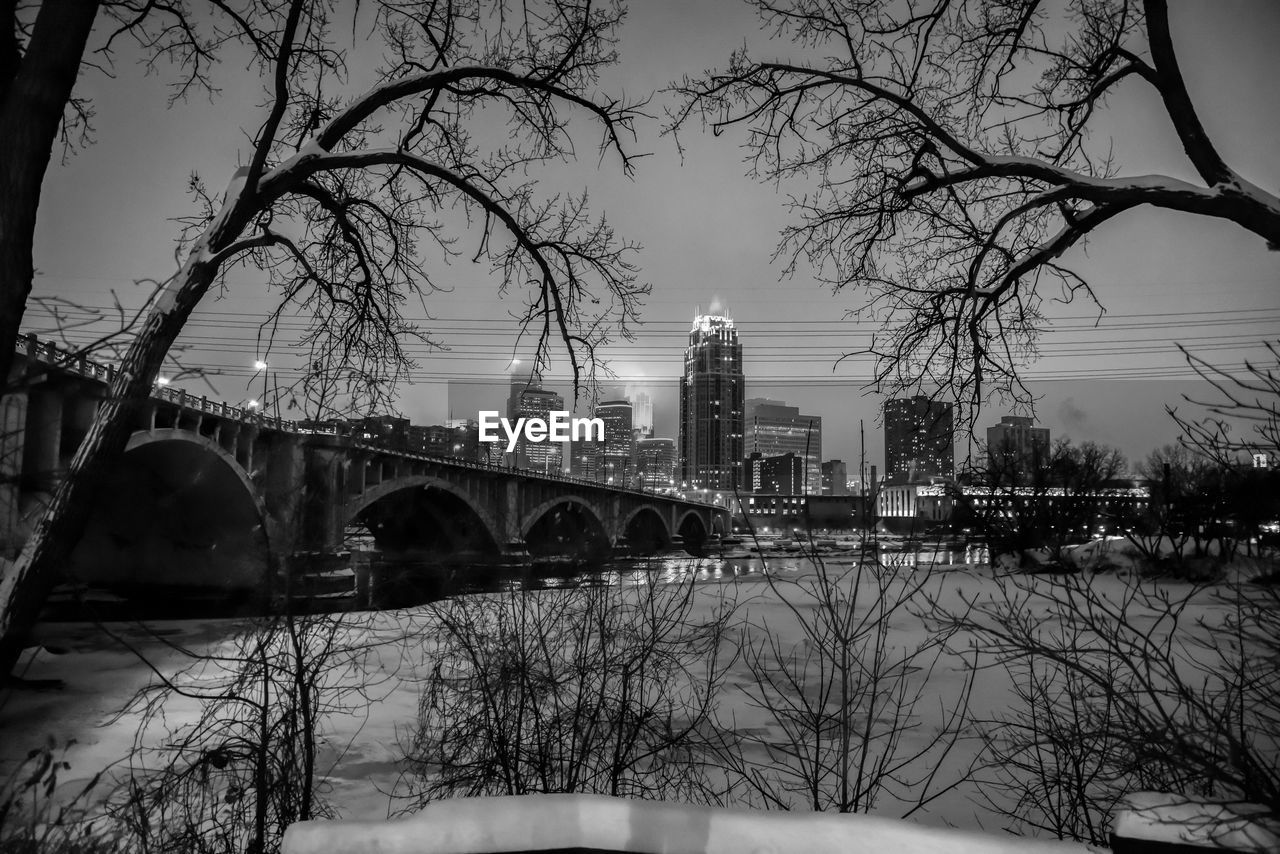 Bridge over river against sky during winter