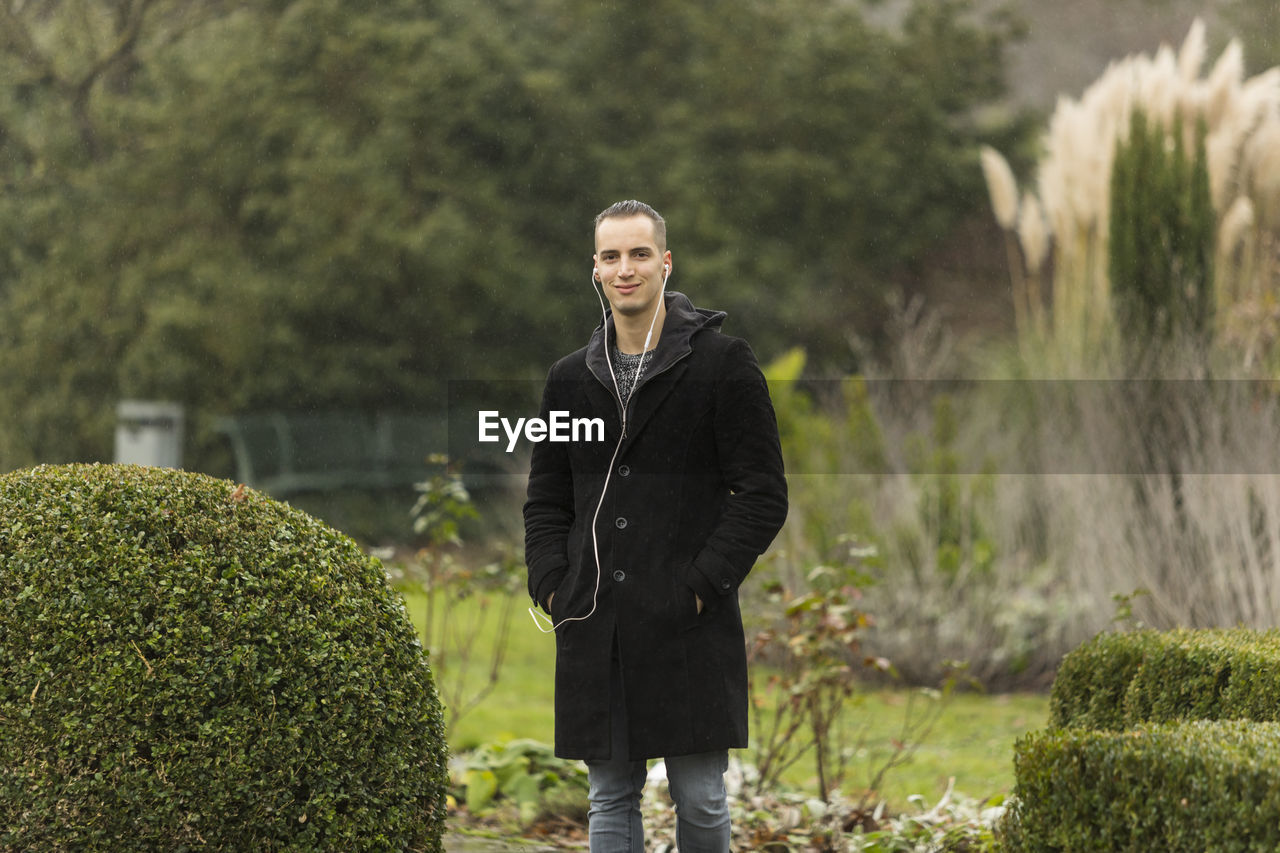 Portrait of man standing at park