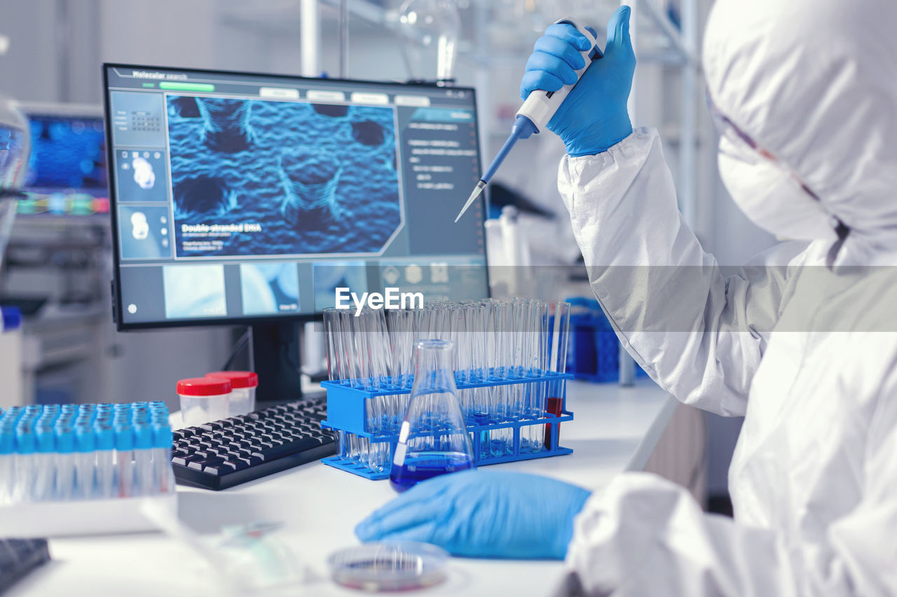 midsection of scientist working on table