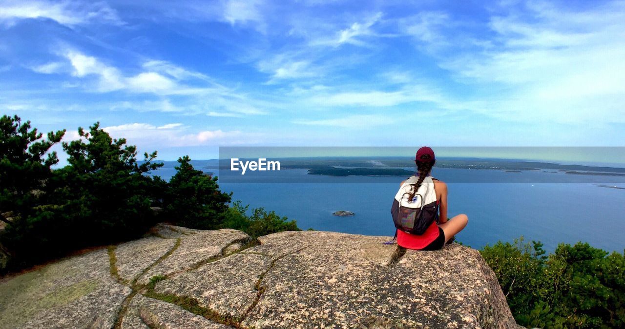 Rear view of woman looking at sea against sky