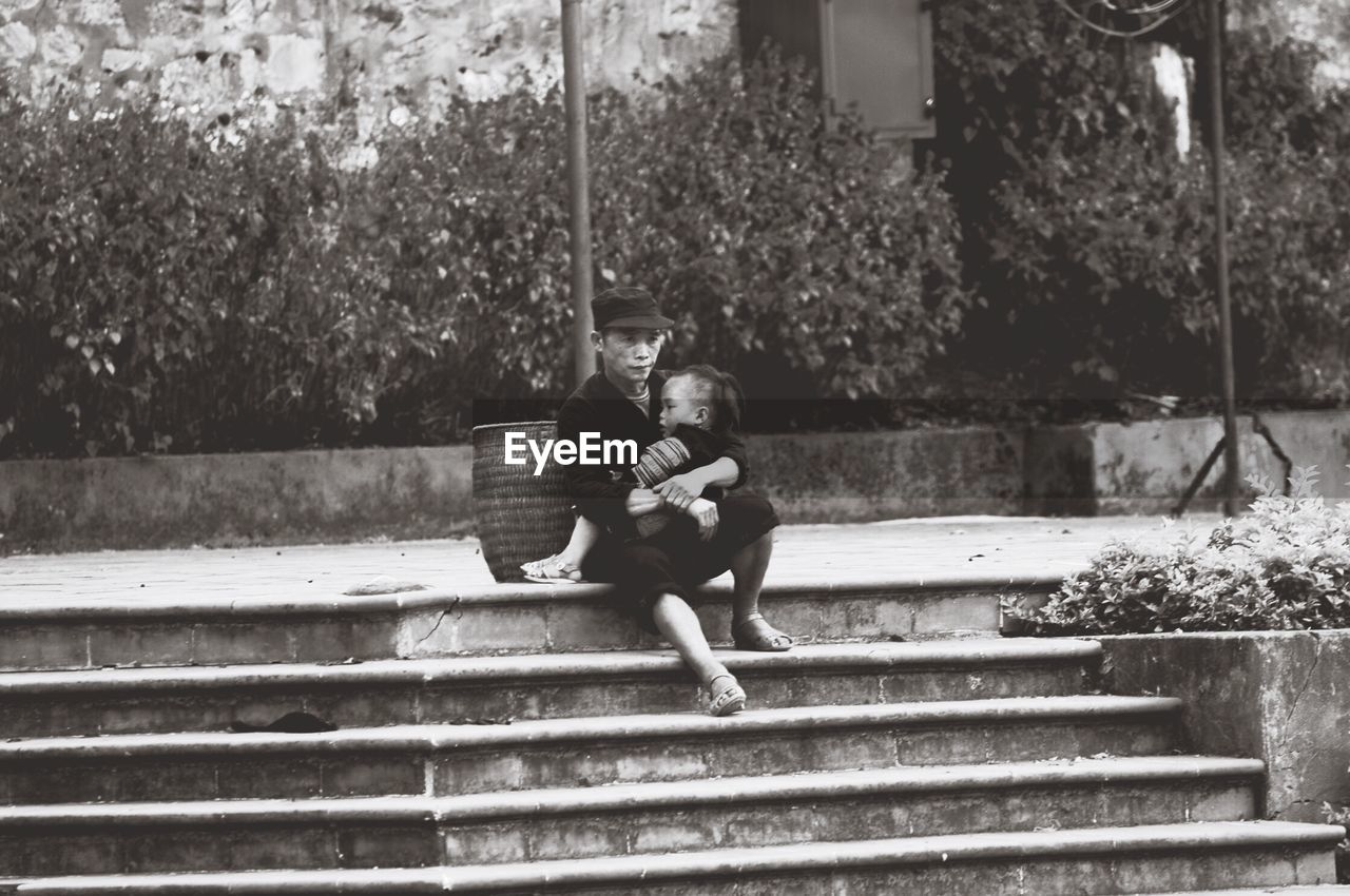 WOMAN STANDING ON STEPS IN PARK