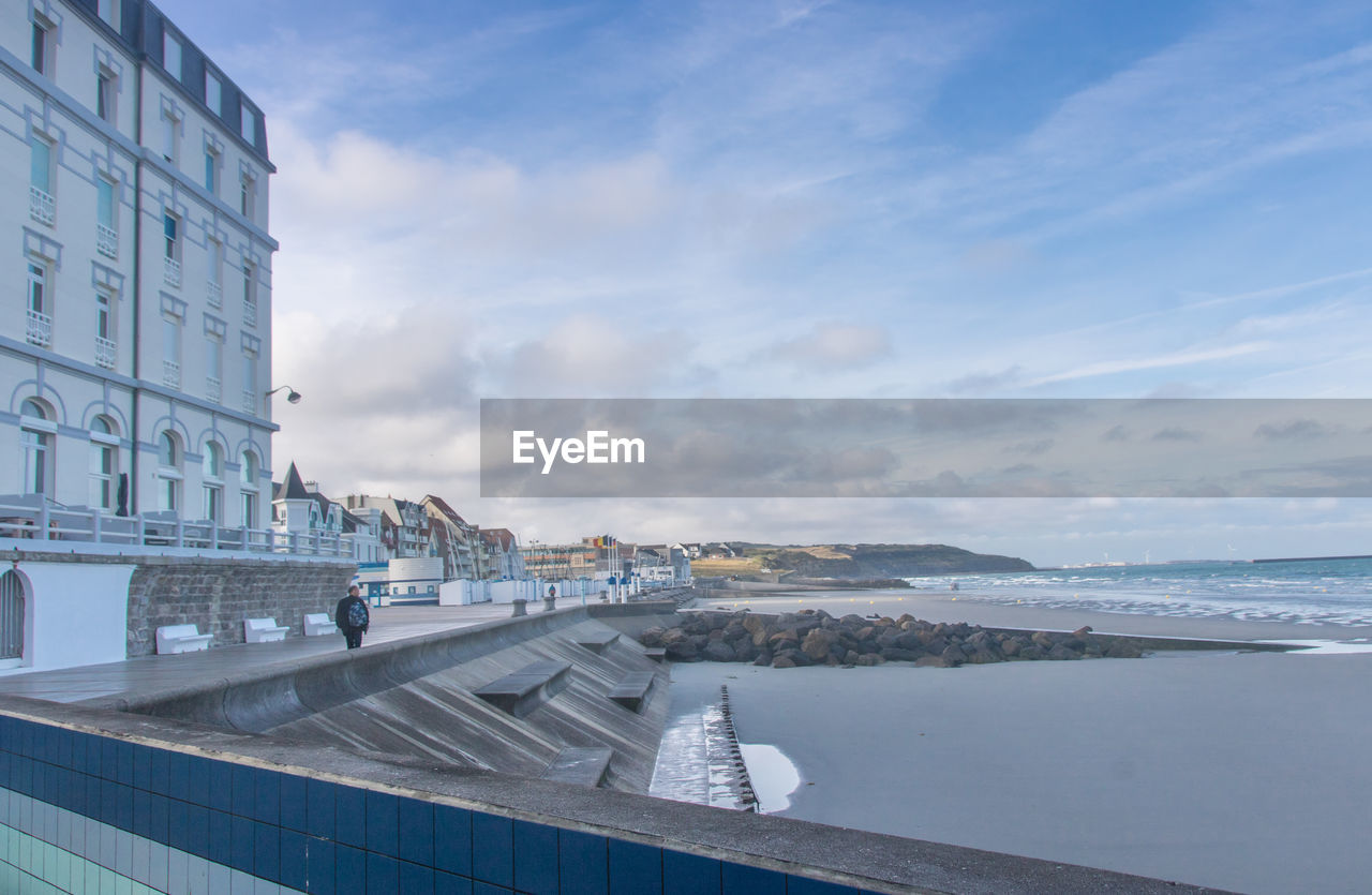 VIEW OF BUILDINGS BY SEA AGAINST SKY