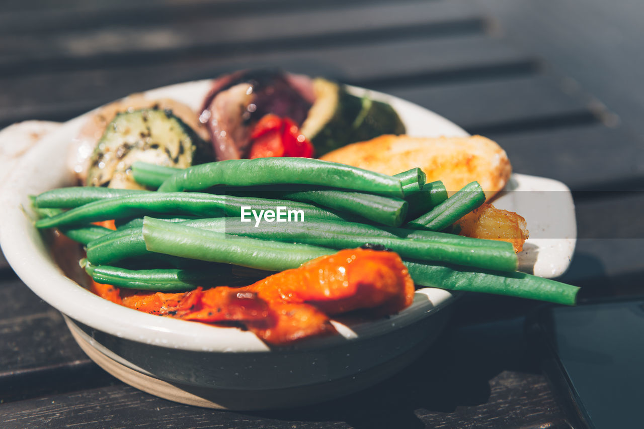 Sunday roast seperate dish of crunchy vegetables. traditional food in english pub