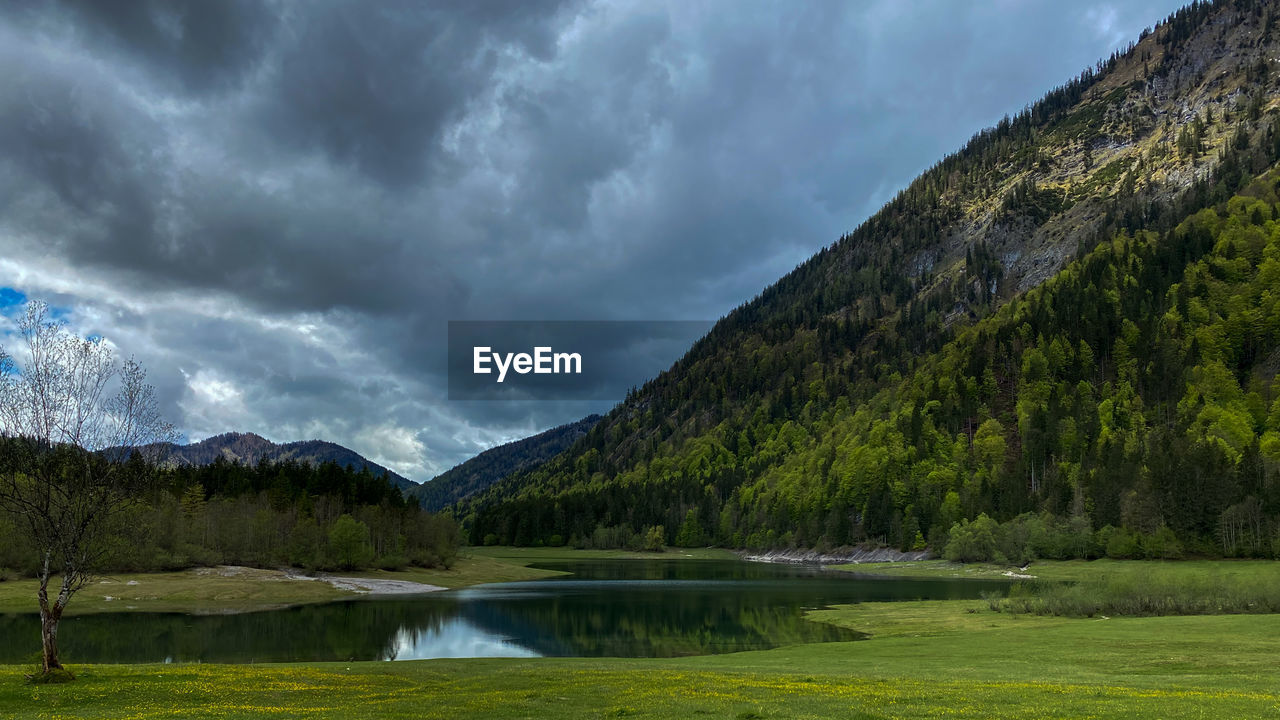 Scenic view of lake lödensee by bavarian mountains against sky, chiemgau 