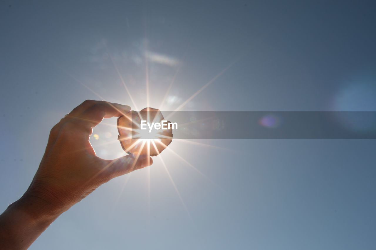 SUNLIGHT STREAMING THROUGH HAND