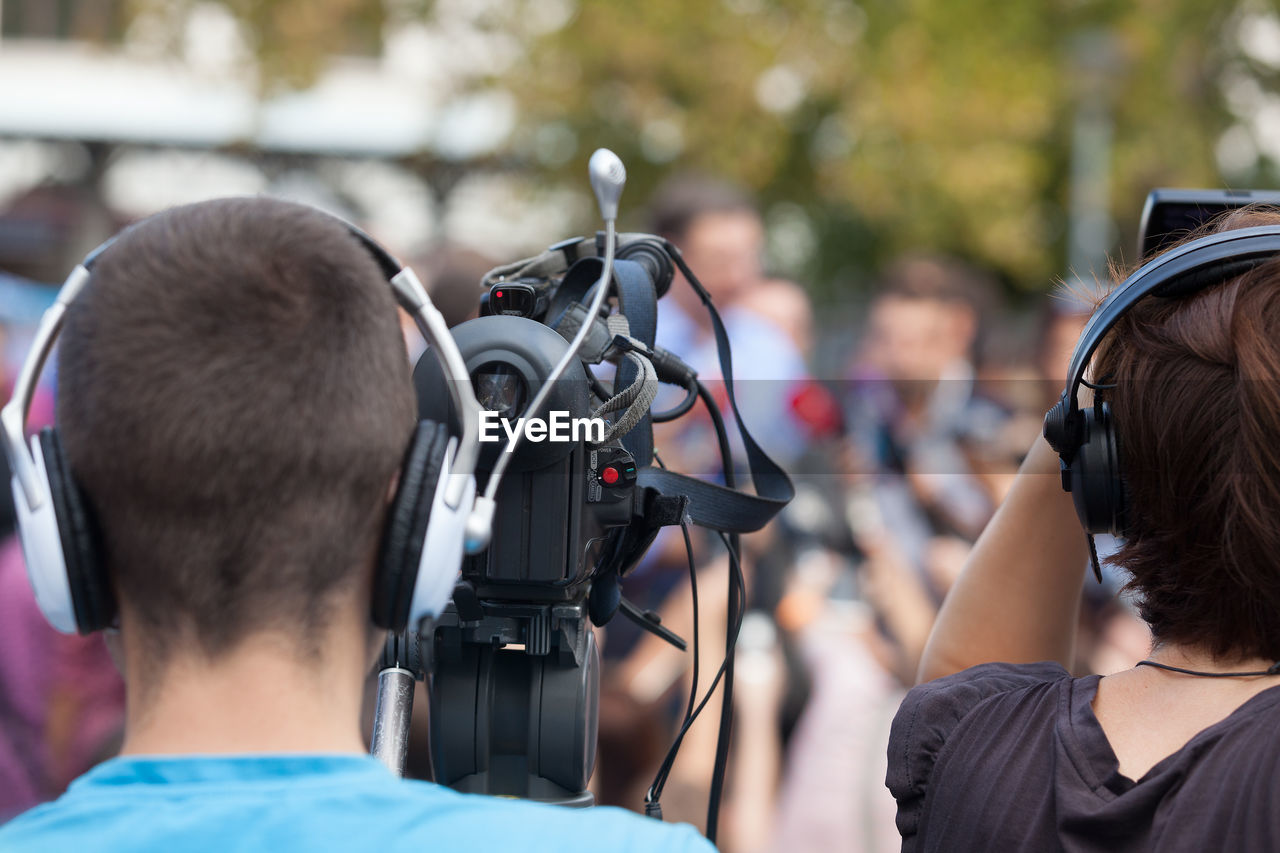 Rear view of journalists on street