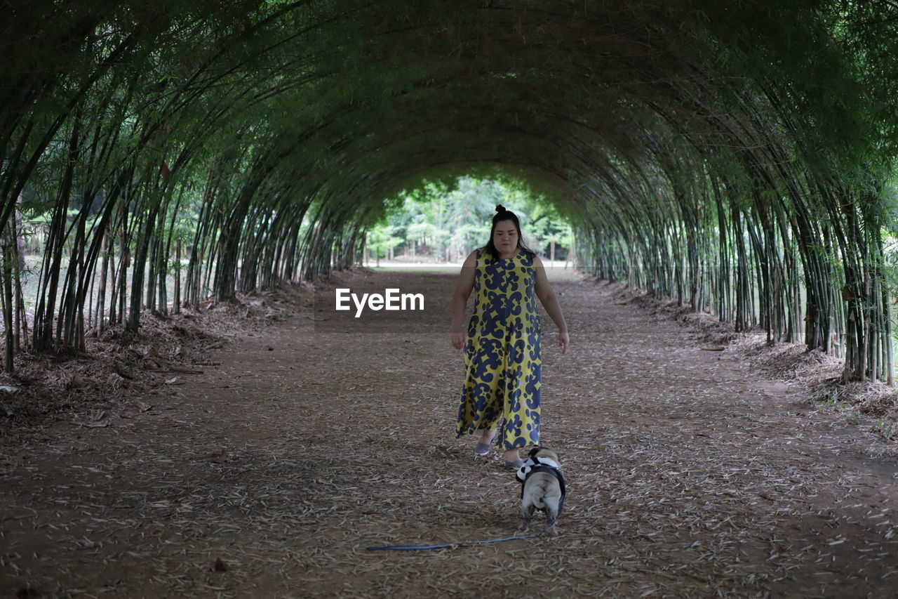 Woman with dog walking at park