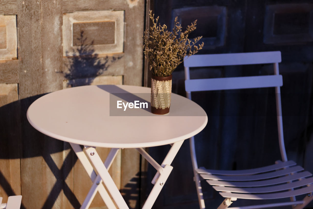 CLOSE-UP OF CHAIR AND TABLE AT HOME