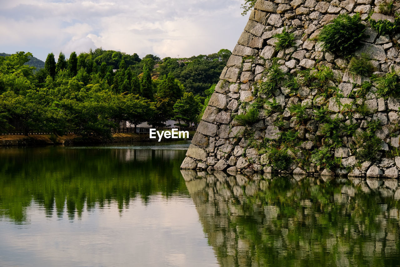 reflection, water, nature, plant, tree, lake, architecture, sky, beauty in nature, flower, no people, tranquility, scenics - nature, built structure, cloud, landscape, travel destinations, environment, leaf, outdoors, travel, green, tranquil scene, autumn, history, reservoir, tourism, building, day, building exterior, land, non-urban scene, the past, growth, forest