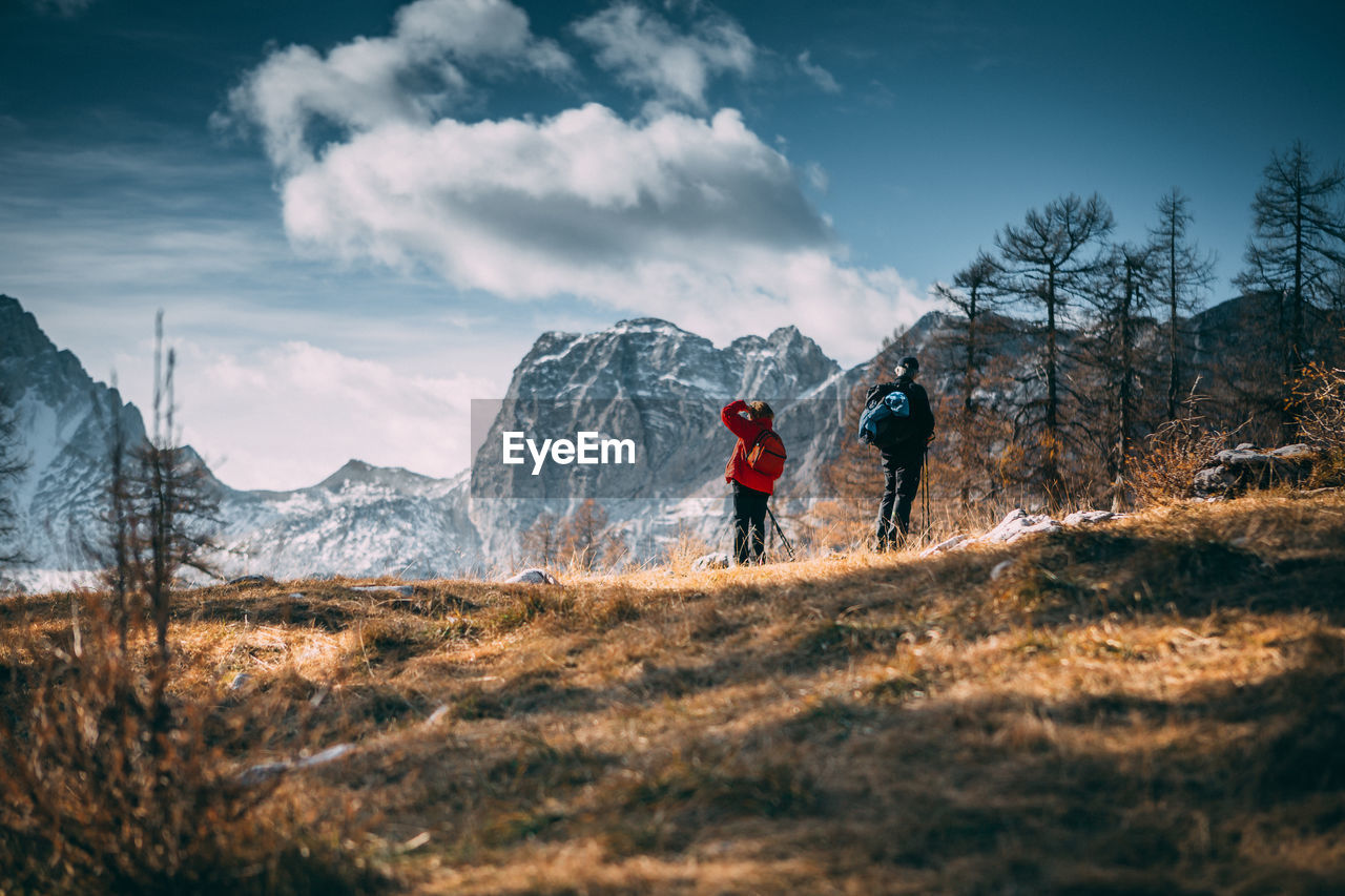 People on mountain against sky