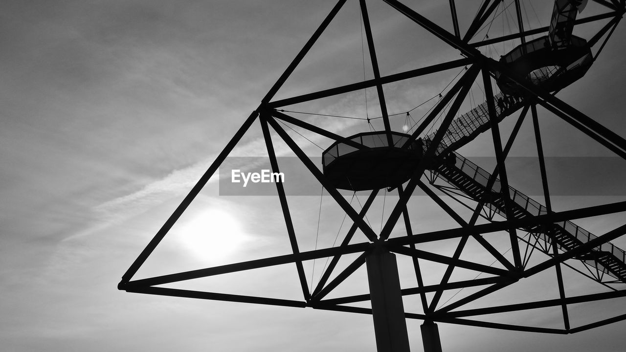 Low angle view of silhouette tower against sky