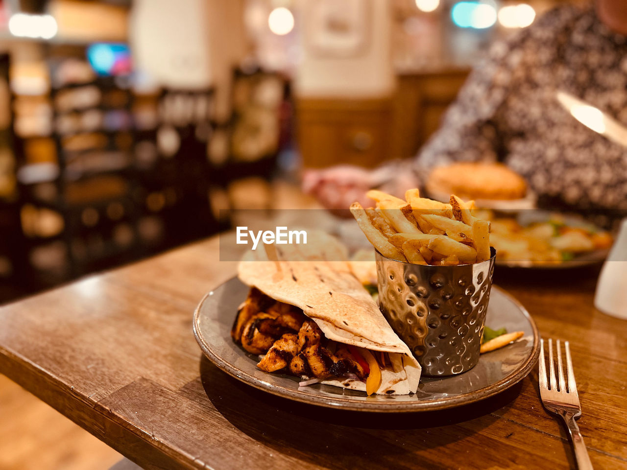 food and drink, food, meal, brunch, restaurant, business, snack, fast food, baked, cafe, dinner, sandwich, taco, breakfast, table, dish, freshness, plate, unhealthy eating, bread, focus on foreground, meat, indoors, bar, adult