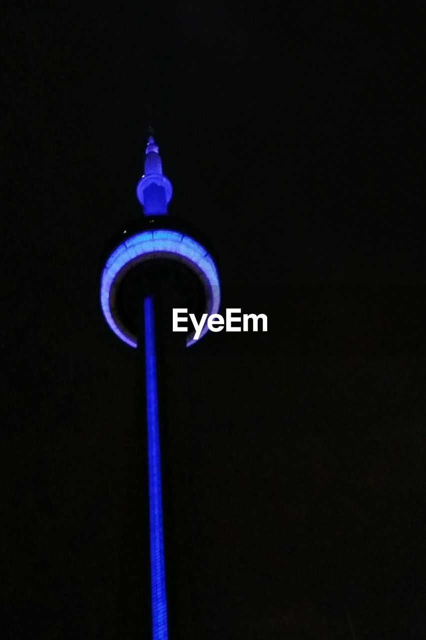 LOW ANGLE VIEW OF TOWER AT NIGHT