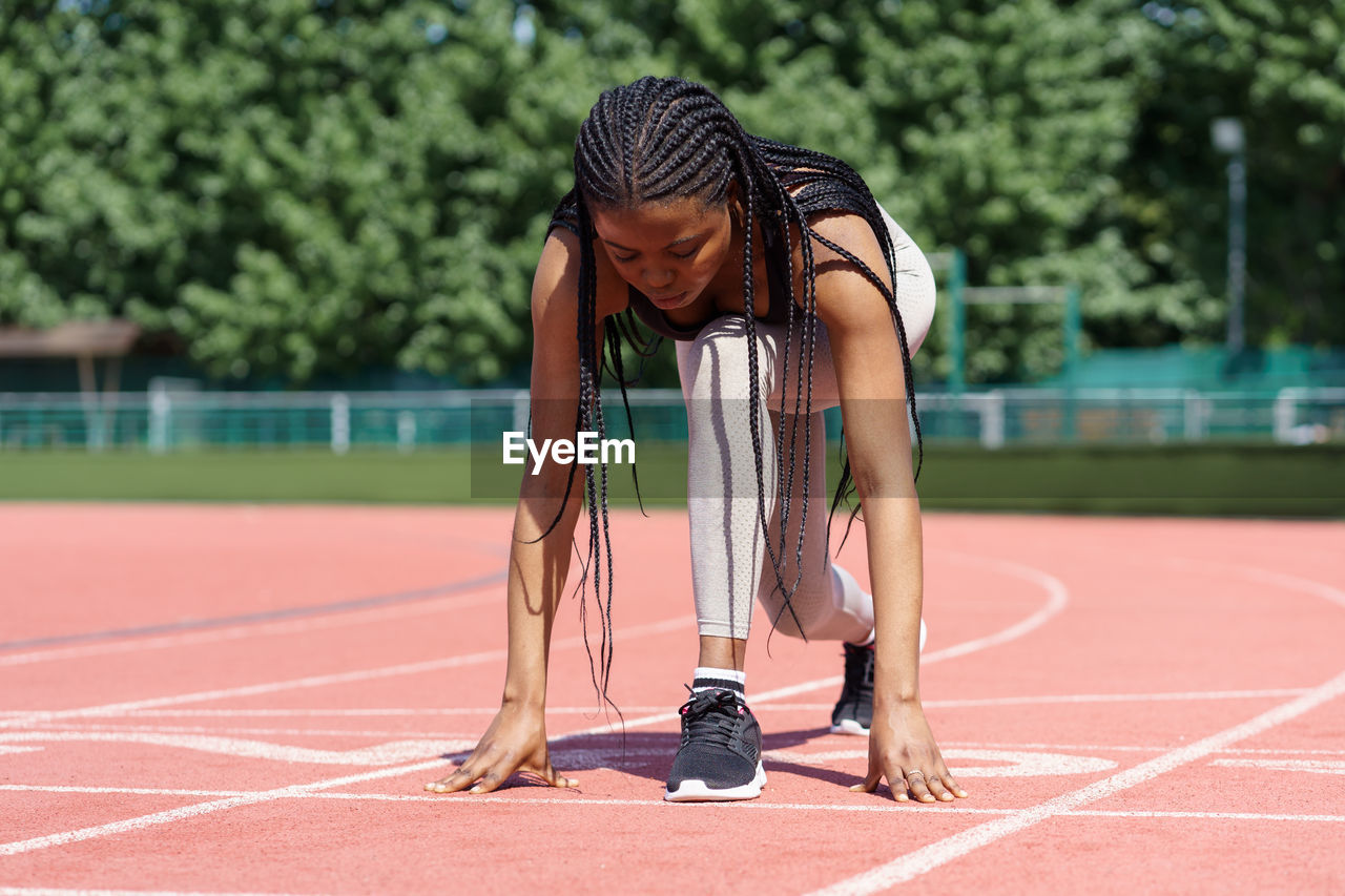 Black girl athlete getting ready for running to fix new record or daily outdoor cardio workout